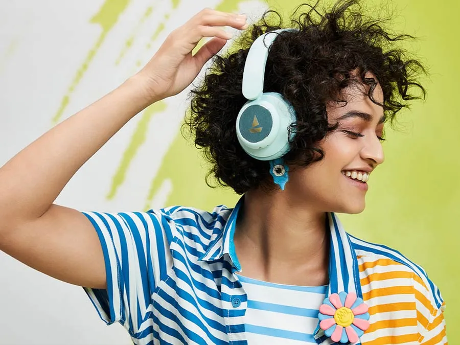 A woman with a smile listening music in headphones